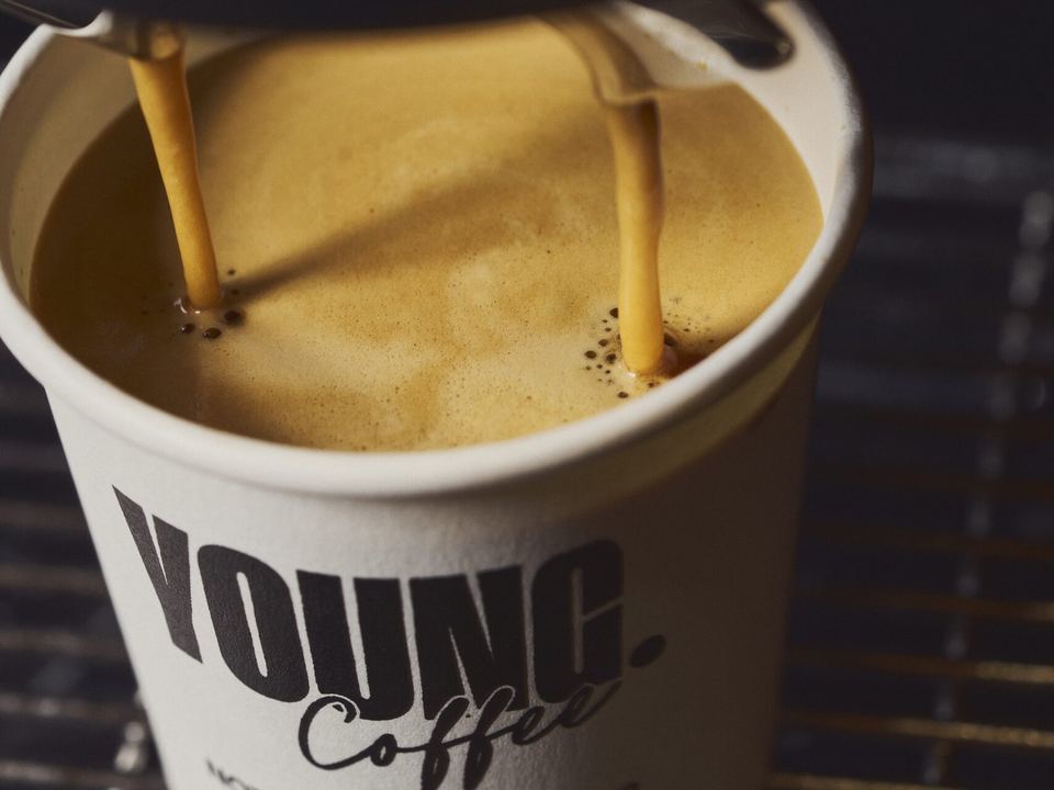 Coffee pouring into a YOUNG Coffee cup