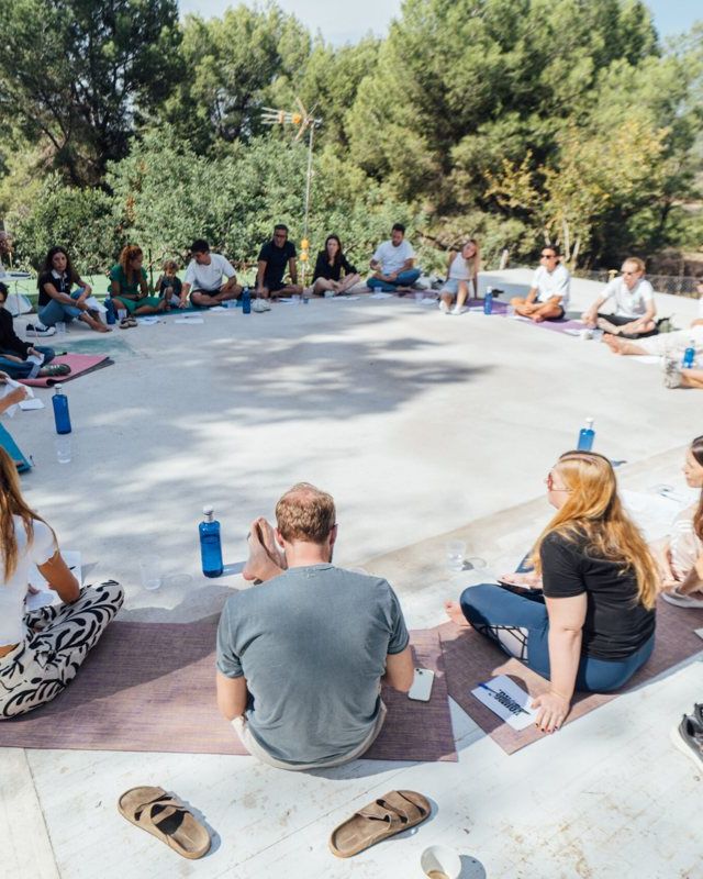 The YOUNG community sitting together in a circle